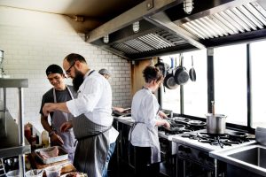 group-chefs-working-kitchen_53876-42734